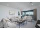 Bright living room with comfortable sofas, modern art, and large windows at 20961 W Pasadena Ave, Buckeye, AZ 85396