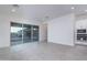 Open living space featuring large sliding glass doors to the backyard, and view of the modern kitchen at 20961 W Pasadena Ave, Buckeye, AZ 85396