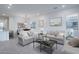 Spacious living room with sofas, modern art, and access to an outdoor patio at 20961 W Pasadena Ave, Buckeye, AZ 85396