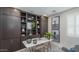 This stylish office includes a built in bookcase, modern decor, and a sleek desk at 20961 W Pasadena Ave, Buckeye, AZ 85396