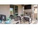 Outdoor patio with fireplace, TV, comfortable seating, and dining table at 20961 W Pasadena Ave, Buckeye, AZ 85396