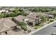 Expansive aerial view of the home showcasing its tiled roof, mature trees, and desert landscaping at 211 W New Dawn Dr, Chandler, AZ 85248