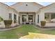Well-manicured backyard with covered patio, lush lawn, and mature landscaping, perfect for outdoor living at 211 W New Dawn Dr, Chandler, AZ 85248