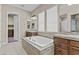 Elegant bathroom featuring a large soaking tub, dual vanities, and a separate toilet room at 211 W New Dawn Dr, Chandler, AZ 85248