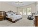 Serene bedroom with large windows, a comfortable bed, and a massage chair for relaxation at 211 W New Dawn Dr, Chandler, AZ 85248