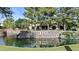 Scenic Fulton Ranch community entrance featuring a waterfall, lush trees, and attractive signage at 211 W New Dawn Dr, Chandler, AZ 85248