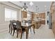 Elegant dining area with a chandelier, a large table, and an open view into the kitchen at 211 W New Dawn Dr, Chandler, AZ 85248