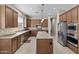 Well-equipped kitchen with a center island, stainless appliances, and stylish tile flooring at 211 W New Dawn Dr, Chandler, AZ 85248
