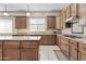 Spacious kitchen featuring granite countertops, wood cabinets, and tile backsplash at 211 W New Dawn Dr, Chandler, AZ 85248