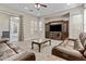 Spacious living room featuring a large media center, plush seating, and a view to the outdoor patio at 211 W New Dawn Dr, Chandler, AZ 85248