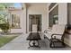 Inviting covered patio with comfortable seating and a view of the beautifully landscaped yard at 211 W New Dawn Dr, Chandler, AZ 85248