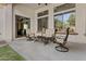 Charming covered patio with comfortable outdoor seating and views of the yard and neighborhood at 211 W New Dawn Dr, Chandler, AZ 85248