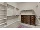 Spacious walk-in closet with built-in shelving, rod space, and a separate dresser unit at 211 W New Dawn Dr, Chandler, AZ 85248