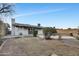 Large backyard featuring an in-ground pool with rock feature, and spacious grass area at 2123 E Radcliffe Dr, Tempe, AZ 85283