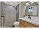 Updated bathroom with walk-in shower, modern fixtures, stylish tile, and wood vanity at 2123 E Radcliffe Dr, Tempe, AZ 85283