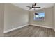 Spare bedroom with wood-look flooring, ceiling fan, and window bringing in lots of natural light at 2123 E Radcliffe Dr, Tempe, AZ 85283