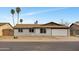 Charming single-story home with brick exterior, desert landscaping, a two-car garage, and tall palm trees in the front yard at 2123 E Radcliffe Dr, Tempe, AZ 85283