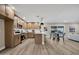 Open-concept kitchen and dining area features wood floors, wood cabinets, an island and stainless steel appliances at 2123 E Radcliffe Dr, Tempe, AZ 85283