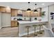 Beautiful kitchen features wood cabinets, stainless steel appliances, a white countertop island with seating, and pendant lighting at 2123 E Radcliffe Dr, Tempe, AZ 85283