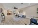 Open-concept living space features wood floors, a ceiling fan, neutral walls, and flows into a modern eat-in kitchen at 2123 E Radcliffe Dr, Tempe, AZ 85283