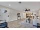 Bright living room features wood floors, neutral walls, a white front door, and flows into a modern eat-in kitchen at 2123 E Radcliffe Dr, Tempe, AZ 85283