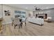 Open concept living and dining area with fireplace, modern furnishings, and wood-look flooring at 2123 E Radcliffe Dr, Tempe, AZ 85283