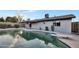 Backyard featuring a pool with diving board, surrounding patio, and attached covered patio at 2123 E Radcliffe Dr, Tempe, AZ 85283