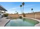 Inviting backyard pool featuring rock waterfall, diving board, and mature palm trees at 2123 E Radcliffe Dr, Tempe, AZ 85283