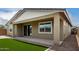 Wide angle exterior shot of backyard showing a covered patio and rock landscaping at 22568 E Rosa Rd, Queen Creek, AZ 85142