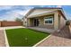 The backyard features a covered patio and manicured rock landscaping at 22568 E Rosa Rd, Queen Creek, AZ 85142