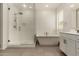 Bright bathroom showcasing a glass shower, soaking tub, and a white vanity at 22568 E Rosa Rd, Queen Creek, AZ 85142