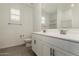 Bathroom with a dual sink vanity and a large mirror at 22568 E Rosa Rd, Queen Creek, AZ 85142