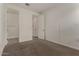 This bedroom offers neutral carpeting and a view into the attached bathroom at 22568 E Rosa Rd, Queen Creek, AZ 85142