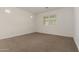 Cozy bedroom offers neutral walls, plush carpet and plantation shutters at 22568 E Rosa Rd, Queen Creek, AZ 85142