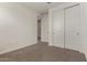 Empty bedroom with carpet, standard closet, and door at 22568 E Rosa Rd, Queen Creek, AZ 85142