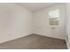 Empty bedroom exhibiting dirty carpet and natural light at 22568 E Rosa Rd, Queen Creek, AZ 85142