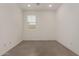Empty bedroom showcasing bright light and tile floors at 22568 E Rosa Rd, Queen Creek, AZ 85142