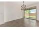 Bright dining area offers modern light fixture and backyard access at 22568 E Rosa Rd, Queen Creek, AZ 85142
