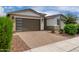 Street view of single-story home with brick driveway and well-maintained landscaping at 22568 E Rosa Rd, Queen Creek, AZ 85142