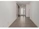 Inviting hallway features tile flooring, white walls and modern doors for a sleek design at 22568 E Rosa Rd, Queen Creek, AZ 85142