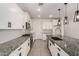 Bright kitchen features granite countertops, white cabinets, and stainless steel appliances at 22568 E Rosa Rd, Queen Creek, AZ 85142