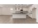 Open kitchen layout featuring a granite island, stainless steel appliances, and white cabinetry at 22568 E Rosa Rd, Queen Creek, AZ 85142