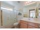 Bathroom with white tub, tiled shower, a neutral vanity, and a large mirror at 2395 E Hancock Trl, Casa Grande, AZ 85194
