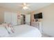 Cozy bedroom featuring carpeted floors, a ceiling fan, a comfortable bed, and closet space at 2395 E Hancock Trl, Casa Grande, AZ 85194