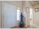 Bright entryway featuring tile flooring, a dolphin statue, and views of the bedroom at 2395 E Hancock Trl, Casa Grande, AZ 85194