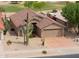 A cozy home with a two car garage, desert landscaping, and a beautiful roof in a golf course community at 2395 E Hancock Trl, Casa Grande, AZ 85194