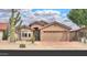 Charming single-story home with a well-manicured front yard and a two-car garage in a sunny neighborhood at 2395 E Hancock Trl, Casa Grande, AZ 85194