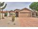 Inviting home with desert landscaping, showcasing the driveway and facade in a sunny neighborhood at 2395 E Hancock Trl, Casa Grande, AZ 85194