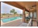 Beautiful pool with a covered patio featuring outdoor furniture overlooking a manicured yard at 2395 E Hancock Trl, Casa Grande, AZ 85194