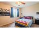Bedroom with carpet flooring, ceiling fan, natural light, and modern decor at 28136 N 90Th Ln, Peoria, AZ 85383